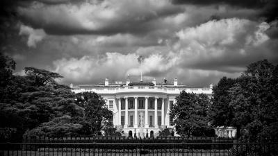 Black and white image of the White House on a cloudy day