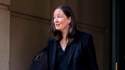 Maurene Comey exiting a building