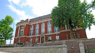 The Supreme Court of Missouri building with blue sky, clouds and trees