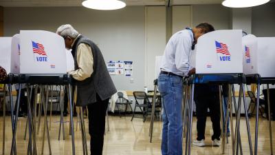 Voters casting ballots in voting booths