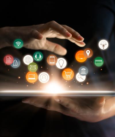 person using tablet with digital marketing icons