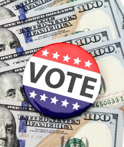 Vote button on top of $100 bills
