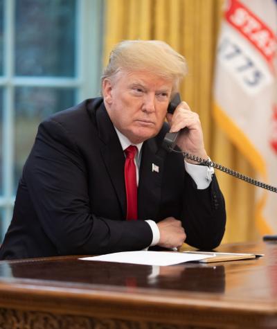 President Donald Trump speaking on the phone in the oval office