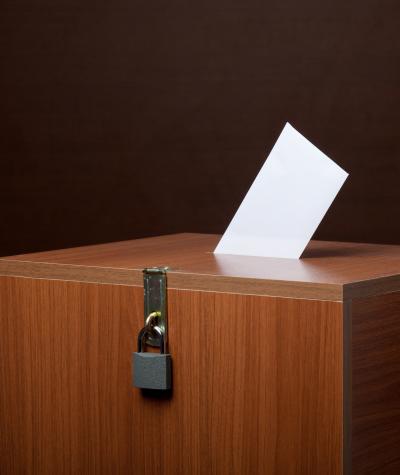 A locked ballot box with a ballot in the top