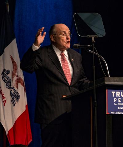 Rudy Giuliani speaking at a podium