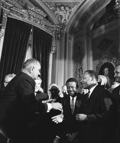 Lyndon Johnson and Martin Luther King Jr. about to shake hands
