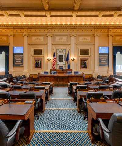 A wide angle view down the aisle of the Virginia House chambers