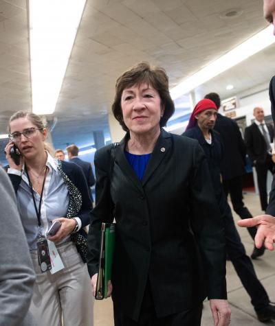 Susan Collins with reporters around her