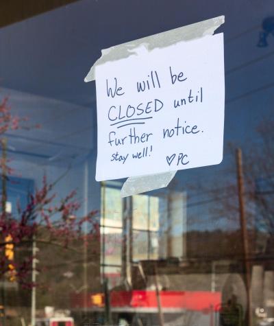 A sign in a window of a cafe reads "We will be closed until further notice. Stay well!"
