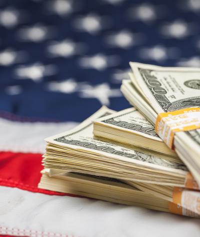 Stacks of bills on an American flag