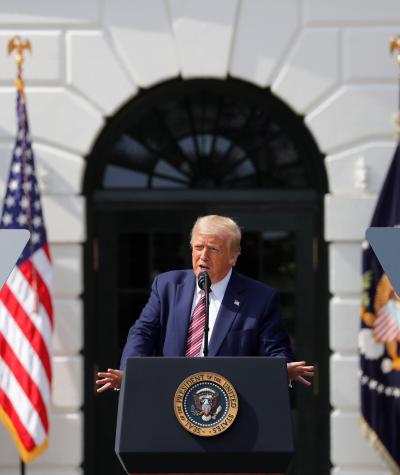 Donald Trump speaking at a podium