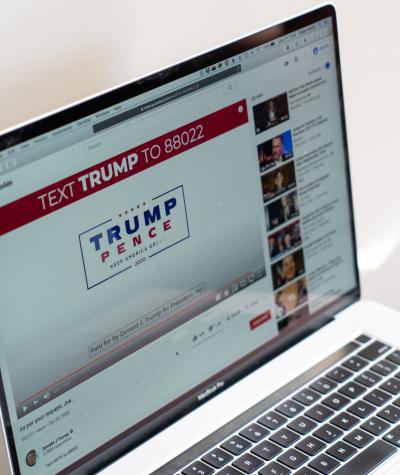 A laptop screen showing a Trump campaign ad on YouTube