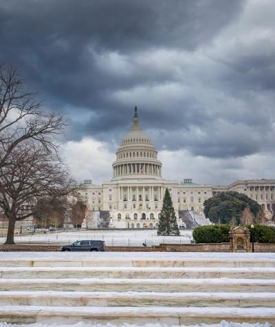 The U.S. Capitol building under dark gray skies.
