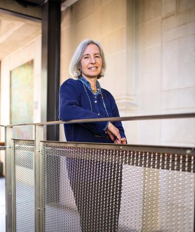 Martha Minow leaning on a railing