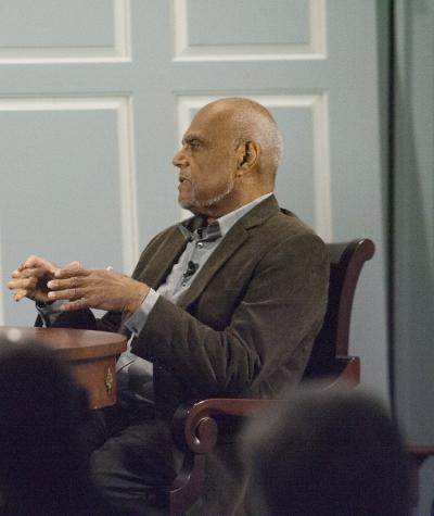Civil rights activists Bob Moses and Julian Bond sit at a table during a discussion event