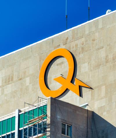 A large yellow "Q" with a lightning bolt on the outside of a building