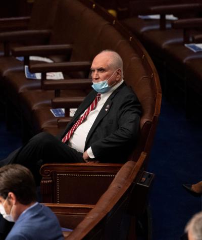 Mike Kelly, wearing a Covid mask, sitting on his own in Congress.