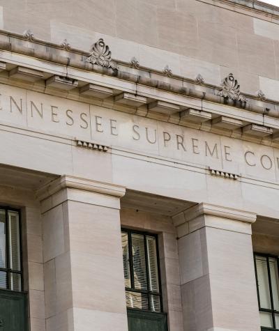 A close up of the words "Tennessee Supreme Court" on the side of a building.