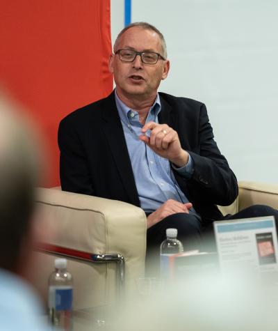 Rick Hasen sitting in a chair and speaking to an audience.