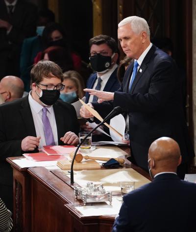  U.S. Vice President Mike Pence and U.S. House Speaker Nancy Pelosi, along with other staff, take part in a joint session of the Congress to certify the 2020 election results at the U.S. Capitol