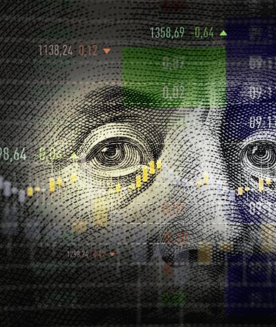 Benjamin Franklin's eyes from a $100 bill overlaid with a stock graph