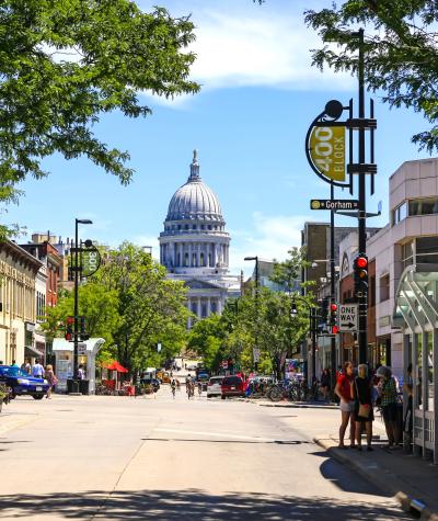The Wisconsin state capitol building seen along a downtown street