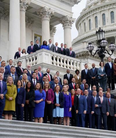 Members of the 118th Congress posing for a photo on the steps of the U.S. Capitol Building.
