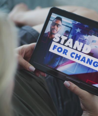 A woman watching a political ad on a tablet