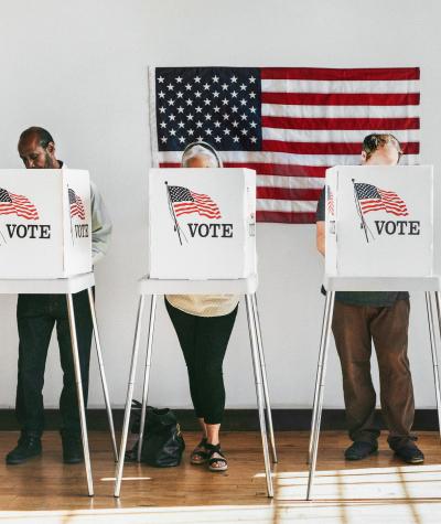A line of voters in voting booths