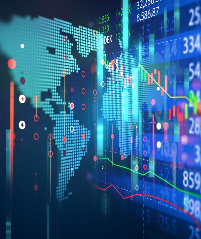 Map of the world on a computer screen overlaid with a stock chart