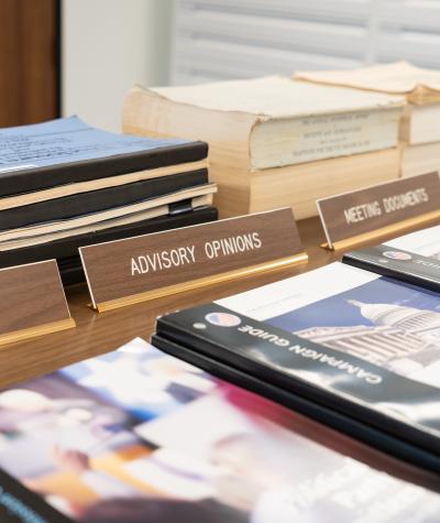 A stack of booklets labeled "Advisory Opinions" sitting on a table