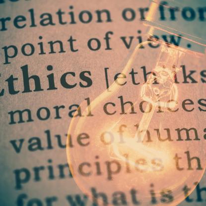 Lightbulb overlaid on definition of "ethics"