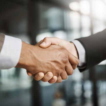 Two men in suits shaking hands