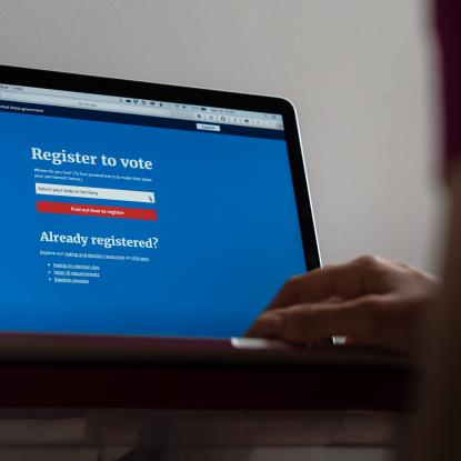 A computer screen displays a website where one can register to vote