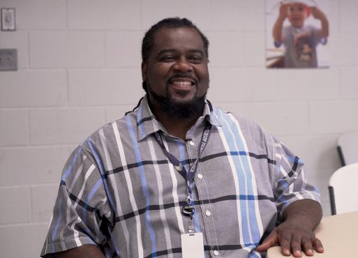 Milton Thomas sitting at a table