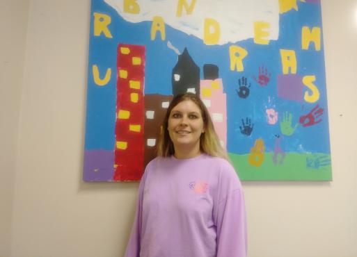 Rachel Manna standing in front of a painting