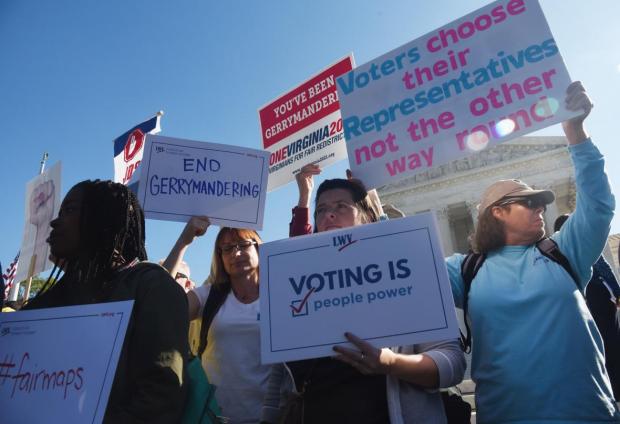 Protesters hold signs for fair maps at the U.S. Supreme Court