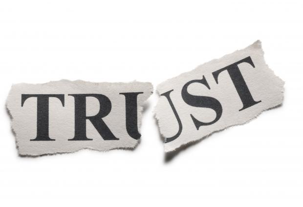 The word "trust" torn in half