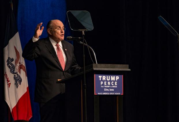 Rudy Giuliani speaking at a podium