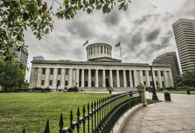 Wide shot of the Ohio capitol building with dark clouds overhead