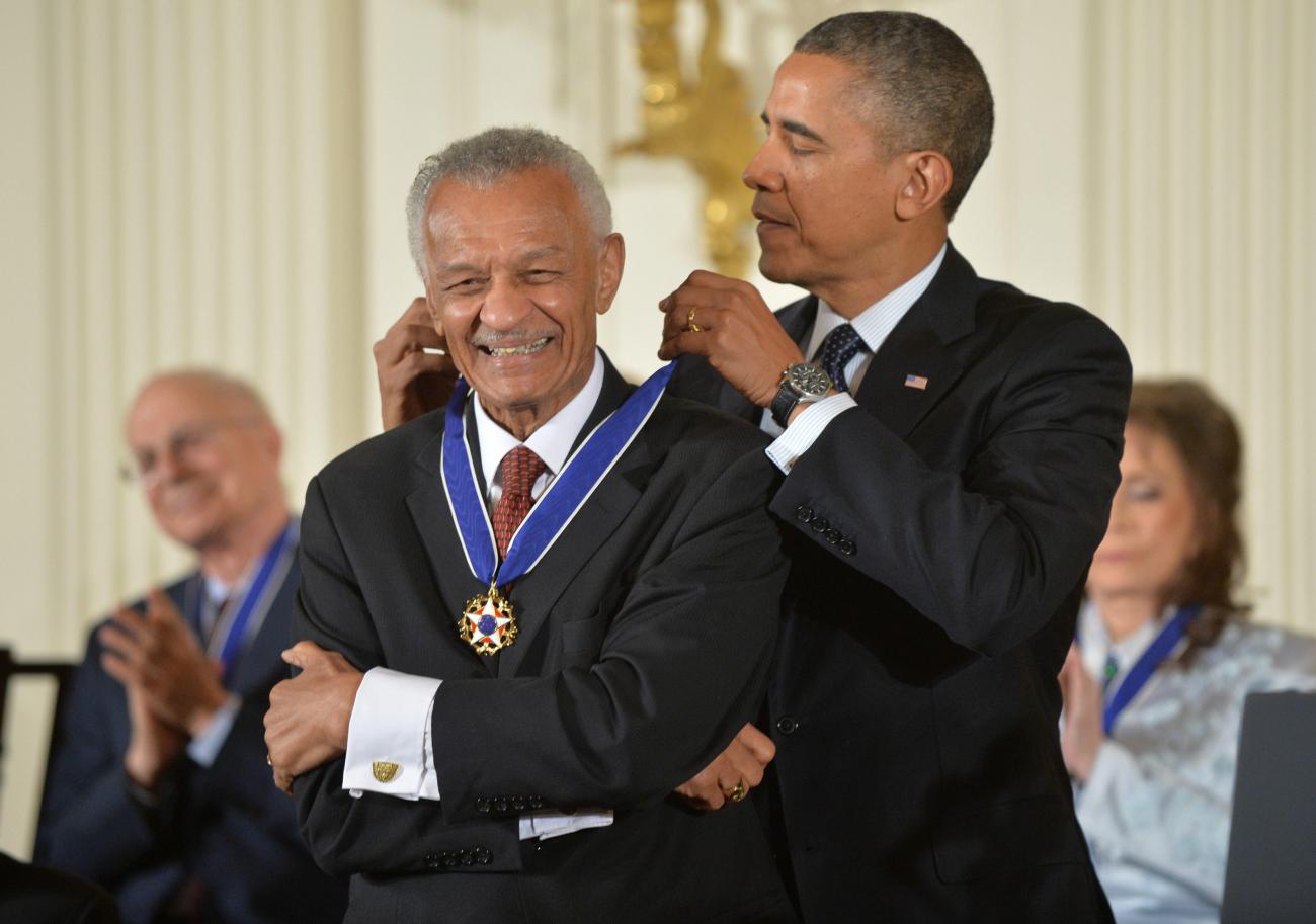 C.T. Vivian smiling while Barak Obama puts a medal around his neck